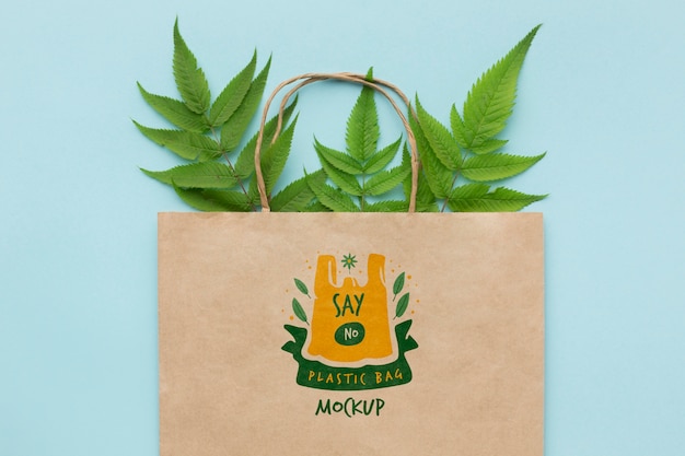 Download Premium PSD | Top view paper bag mock-up with leaves