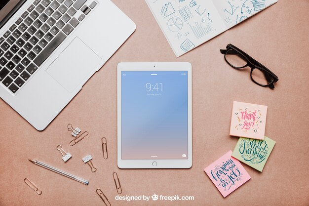 Top view workspace mockup with tablet PSD Template