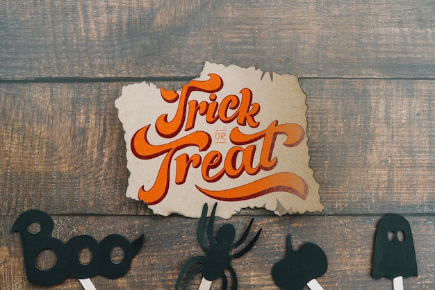 Torn paper mockup with halloween concept and elements on bottom PSD Template