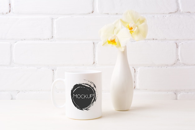 Download White coffee mug mockup with soft yellow orchid in vase ...