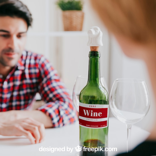 Wine mockup with man at table PSD Template
