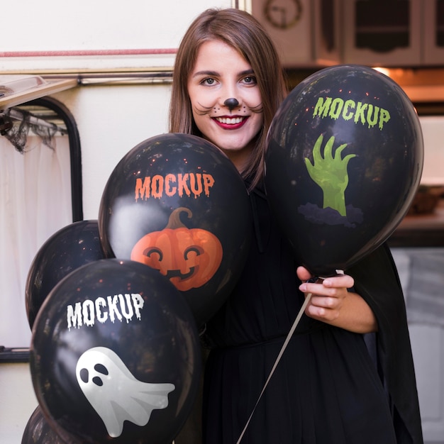 Download Free Psd Woman In Halloween Costume Holding Mock Up Balloons PSD Mockup Templates