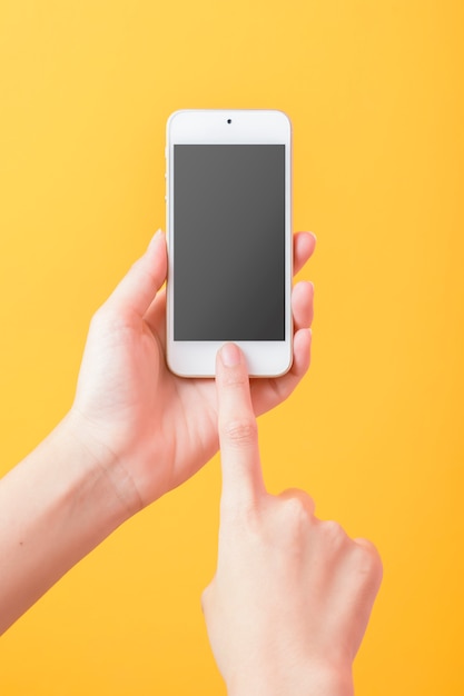 Premium Psd Woman Hand Is Holding Smart Phone Mockup On Yellow Background
