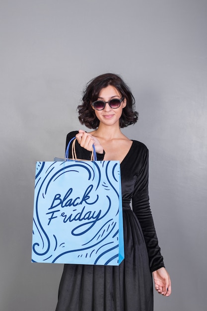 Download Woman holding shopping bag mockup with black friday ...