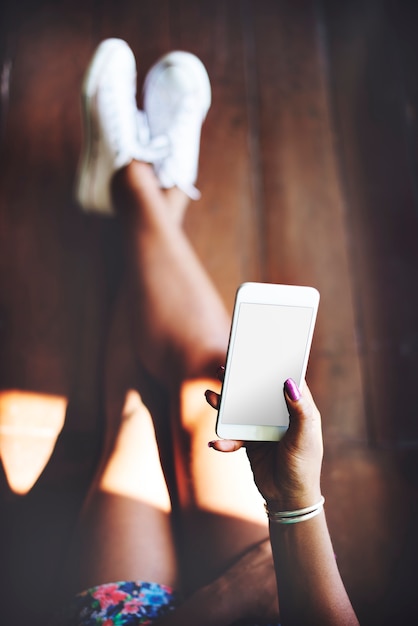 Woman using a smartphone with an empty screen PSD Template