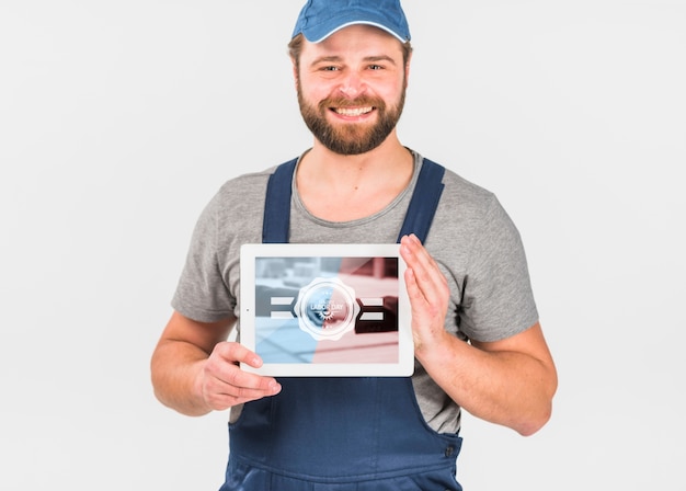 Download Worker holding tablet mockup for labor day | Free PSD File