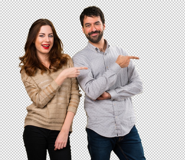 Young couple pointing to the lateral Premium Psd