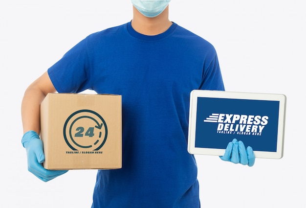 Download Young delivery man holding paper cardboard box and tablet ...