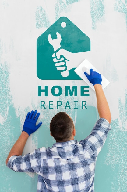 Download Young handyman repair the mock-up wall | Free PSD File