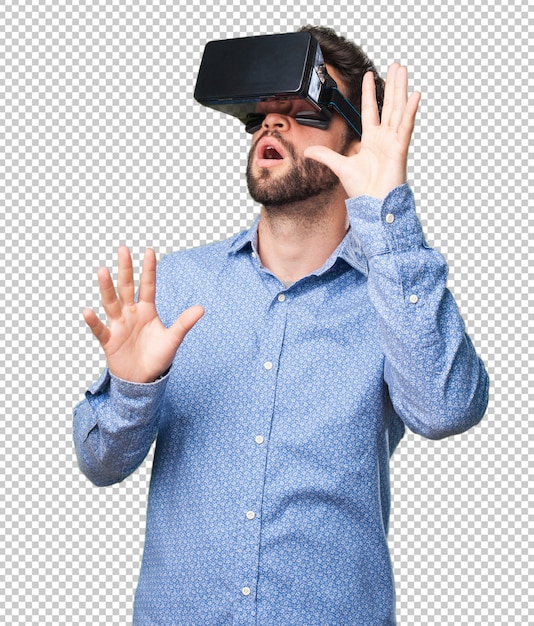Young man looking through a virtual reality glasses Premium Psd