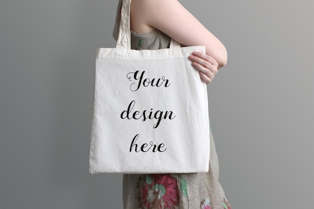 Download Premium PSD | Young woman carrying eco cotton tote bag ...