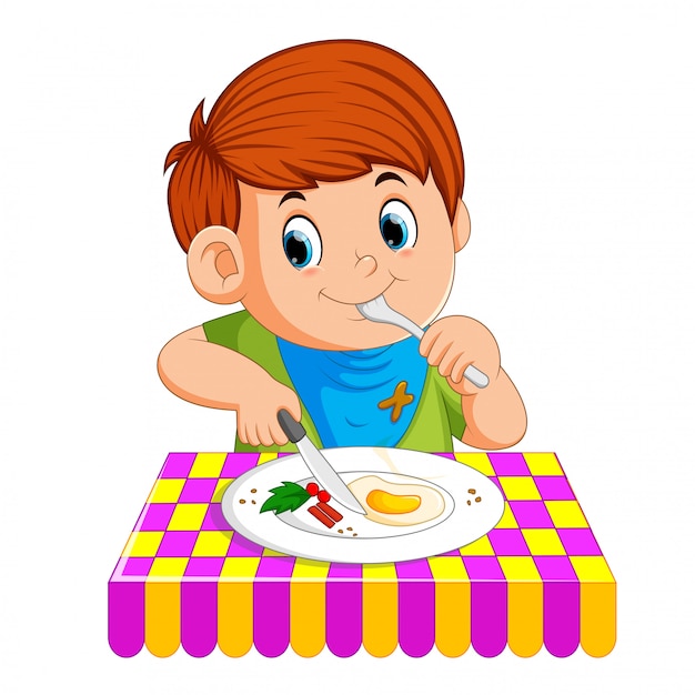 Мальчик сидит, наслаждаясь завтраком | Премиум векторы