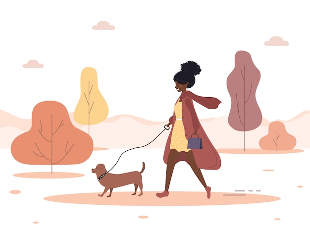秋の背景 若いアフリカ人女性は森の中を犬と一緒に歩きます ダックスフントまたはプードルと茶色のコートのコンセプトハッピーガール フラットスタイルのイラスト プレミアムベクター