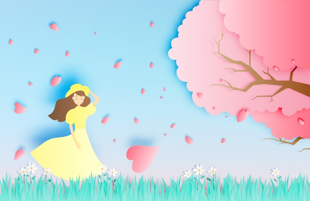 Beautiful girl with cherry blossom tree in the grass field paper art style vector illustration Premium Vector