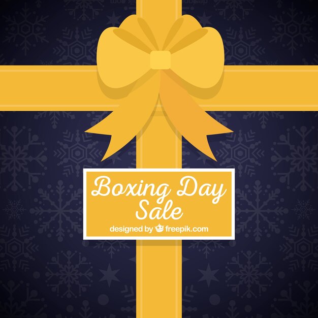 Boxing day background in a shape of a gift box\
with a yellow ribbon