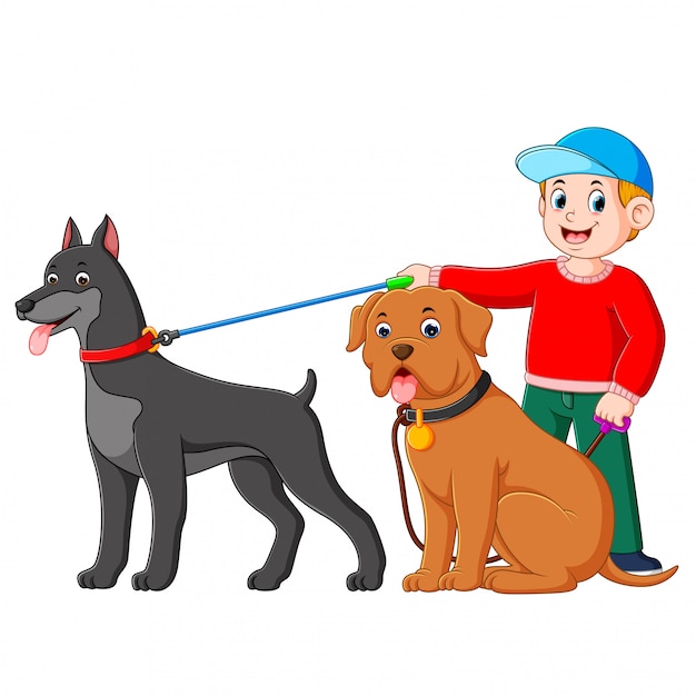 A boy using the red sweater is standing at the back of two big dog Premium Vector