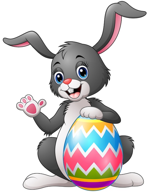 Premium Vector | Cartoon bunny waving hand with holding easter egg