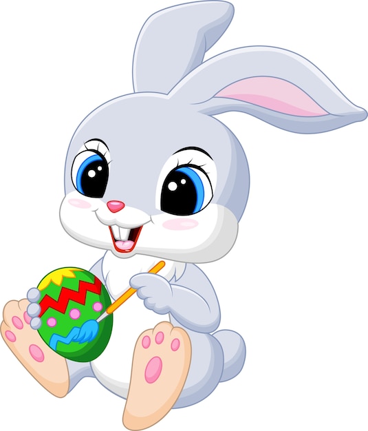 Download Cartoon funny easter bunny painting an egg | Premium Vector