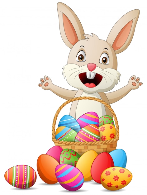 Premium Vector | Cartoon rabbit with easter eggs in basket. illustration