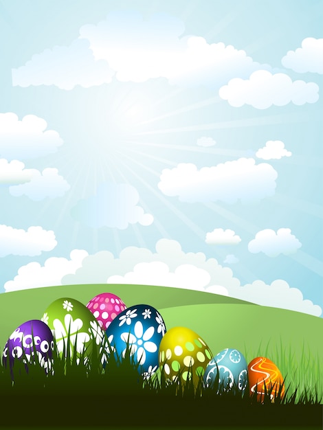 Colourful easter eggs in grass on a sunny\
landscape background