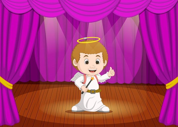 Download Cute little boy wearing angel costume on stage | Premium Vector