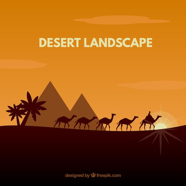 Desert landscape with pyramids and\
caravan