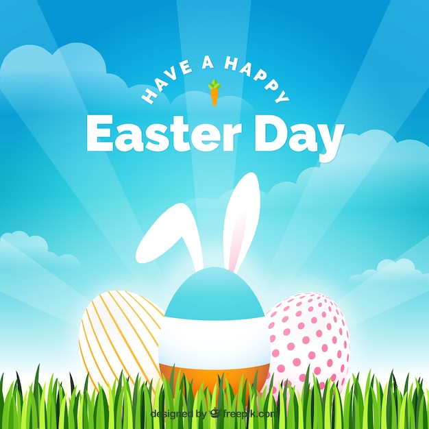 Grass background with easter eggs and bunny\
ears