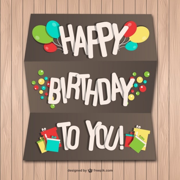 Happy Birthday paper card on wood wall