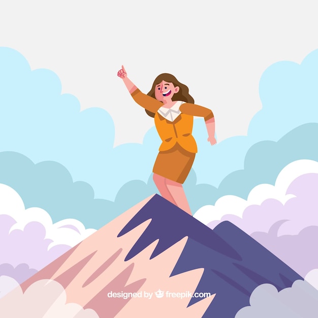 Happy businesswoman on the top of a
mountain