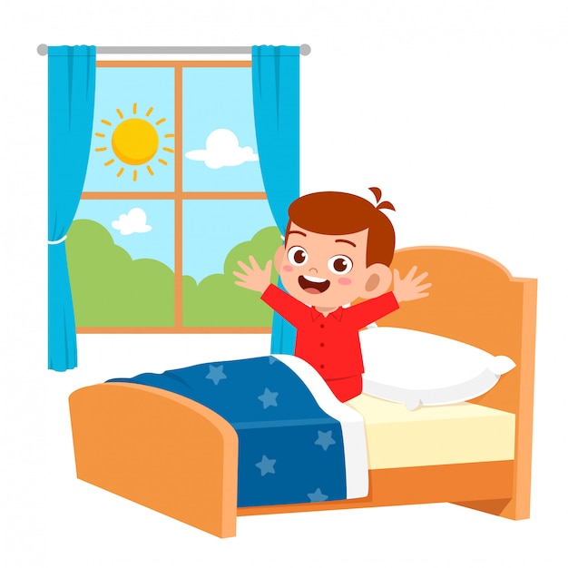 Happy cute little kid boy wake up  in the morning Premium 