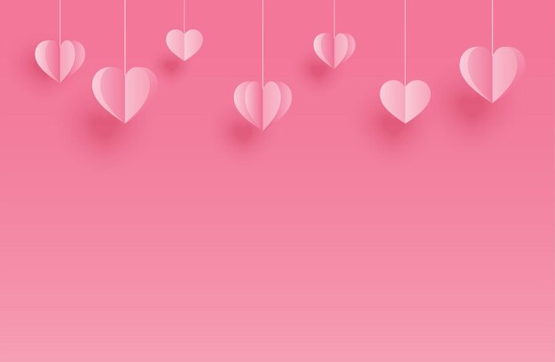 ピンクのパステル背景に掛かっている紙のハートと幸せなバレンタインデーのグリーティングカード プレミアムベクター