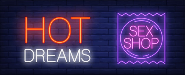 Hot Dreams Sex Shop Neon Sign Purple Condom Package Against Brick Wall 