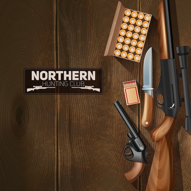 Hunting weapon and bullets set on wooden\
texture background