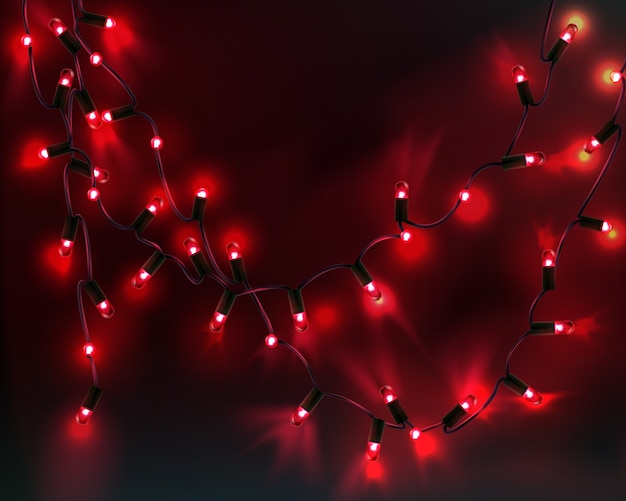 テキスト用のスペースと暗い背景に分離された赤い電球とクリスマスの花輪の画像 プレミアムベクター