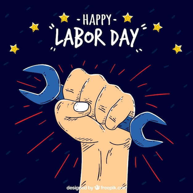 Labor day background with hand holding a\
tool
