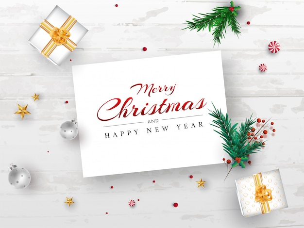 松の葉 メリークリスマスと新年あけましておめでとうございますメッセージカード葉 赤い果実 星 つまらないもの 白い木製テクスチャ背景のギフトボックス プレミアムベクター