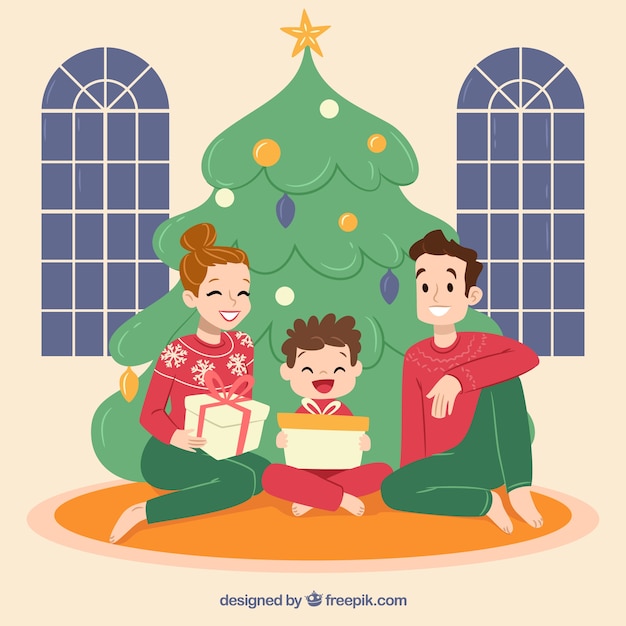 Download Free Vector | Mom, dad and son sitting under the christmas tree
