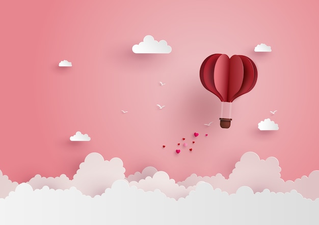 Premium Vector | Origami made hot air balloon fly over grass with heart