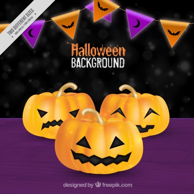 Free Vector | Purple background with three halloween pumpkins