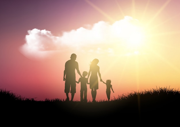 Silhouette of a family walking against a sunset\
sky