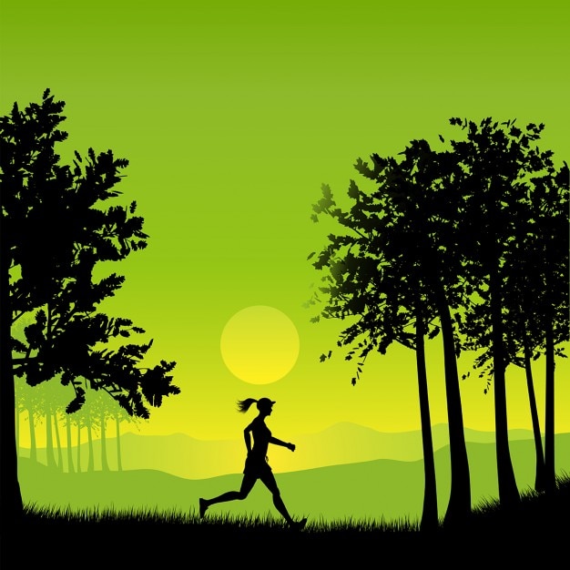 Silhouette of a woman jogging in the\
countryside