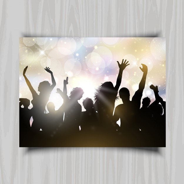 Silhouettes of people dancing on a bokeh lights\
background