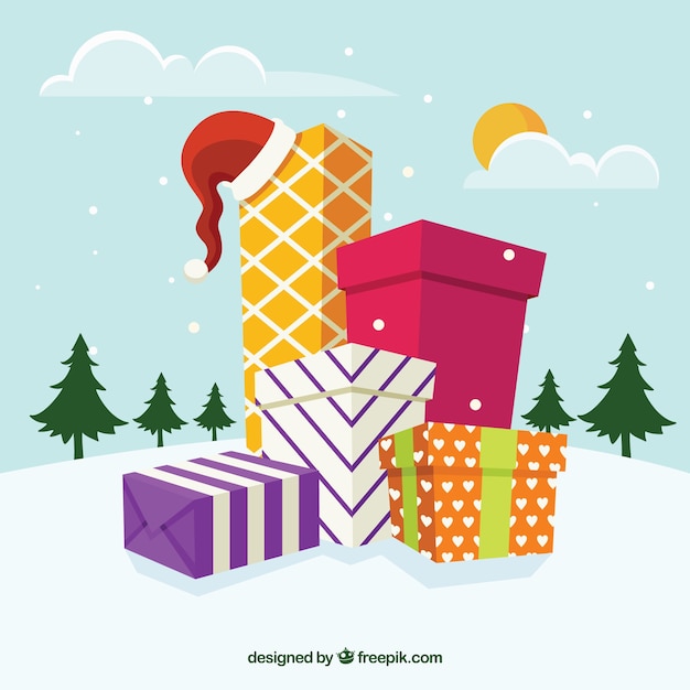 Free Vector | Snowy landscape background with gift boxes