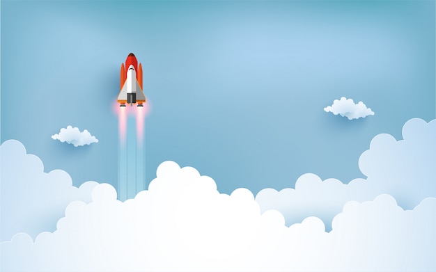 宇宙船のイラストが雲の上を飛んでいます 紙アートデザイン プレミアムベクター