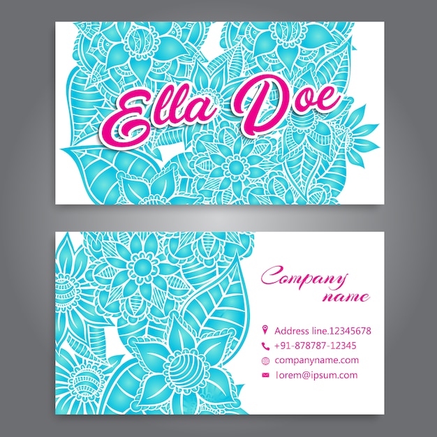 White business card with blue flowers and pink
details
