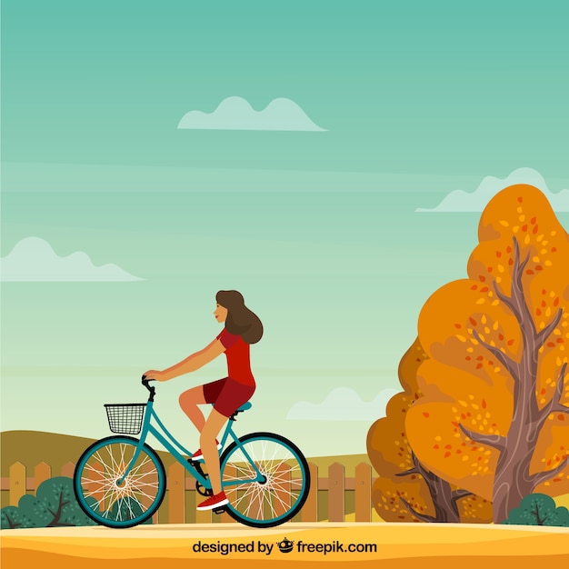 Woman with bicycle and autumnal\
landscape