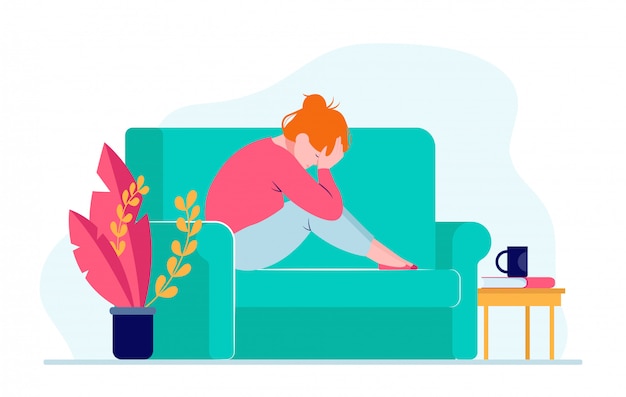 Young depressed woman sitting on sofa and holding head Free Vector