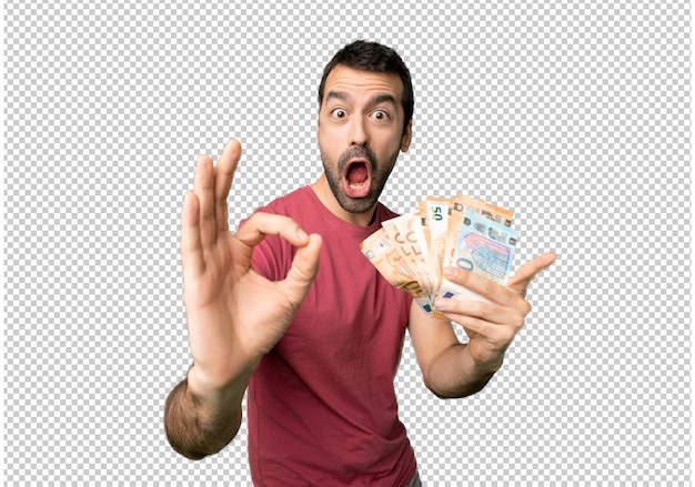 Bemannen sie das nehmen eines geldes, das okayzeichen mit zeigt und einen daumen herauf geste gibt Premium PSD