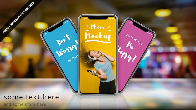 Drei apple iphone x auf einer reflektierenden oberfläche mit bokeh Premium PSD