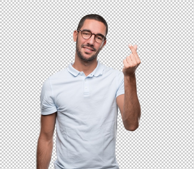 Glücklicher junger mann mit einer geste des haltens von etwas mit seinen fingern Premium PSD